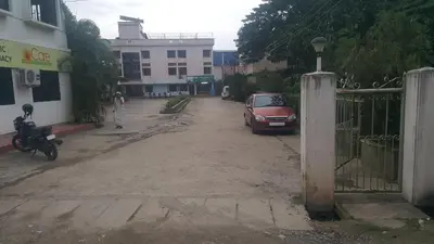 a car parked on the side of a dirt road at Sithara Guest House in Palakkad