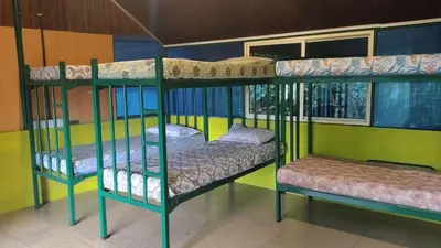 a room with two bunk beds in a room at Hornbill Paradise, Munnar in Viripara