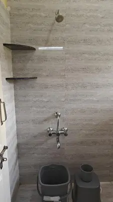 a bathroom with a toilet and a sink at Gamani in Mysore