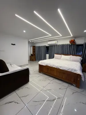 a bedroom with a bed and a tub in it at Ichakkans beach resort in Irimbranallūr