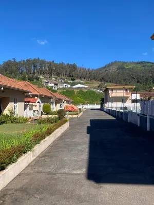 a walkway in a residential neighborhood with houses at Neom Valley in Ketti