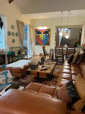 a living room with leather couches and a table at Neom Valley in Ketti