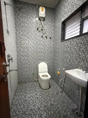 a bathroom with a toilet and a sink at The Residence 267 Home Stay in Mysore