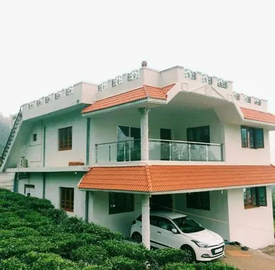a white car parked in front of a building at Hillside haven ooty in Ooty