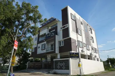 a black and white building on the side of a street at Luxury Stays in Coimbatore