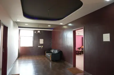 a room with a couch and a tv on the ceiling at Luxury Stays in Coimbatore