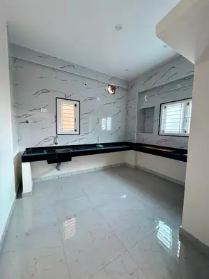 a empty room with a counter and two windows at Nexusliving in Coimbatore