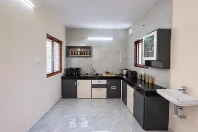 a kitchen with a sink and a counter top at House of KRM - Nilgiris Outlook in Kāramadai