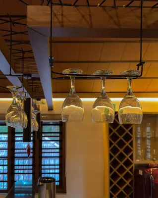 a group of glass lights hanging from a ceiling at Pochans Zen in Thattakād