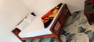 a bed in a room with at Nakshatra Home Stay in Vattavada