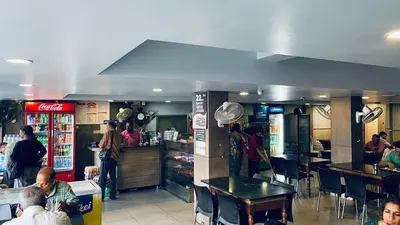 a group of people in a fast food restaurant at Saravana tourist home in Kozhikode