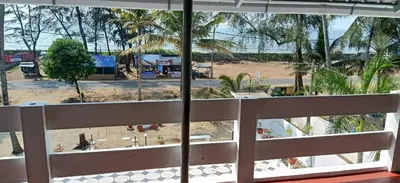 a view of a beach from a balcony at Garden Beach in Cochin