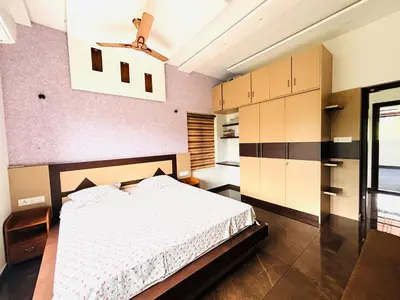 a bedroom with a white bed in a room at Tanis serenity in Meenangadi