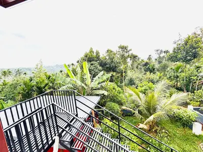 a view of a balcony of a house with trees at Tanis serenity in Meenangadi