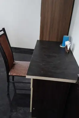 a black desk with a chair and a blue box of tissues at PK Homestay in Coimbatore