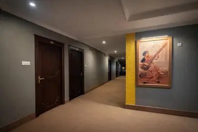 a hallway with a painting of a baseball player on the wall at Chandragiri INN in Kalpetta