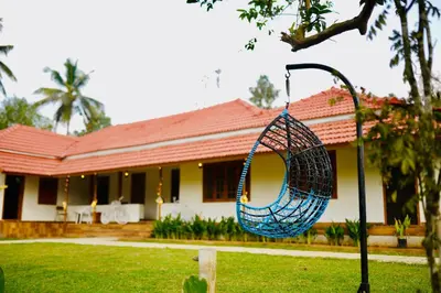 a swing in front of a house at 50 Fables Vintage Kerala Pool Home in Pulpally