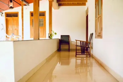 a hallway with chairs and a table in a house at 50 Fables Vintage Kerala Pool Home in Pulpally