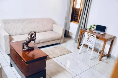 a living room with a couch and a table at 50 Fables Vintage Kerala Pool Home in Pulpally