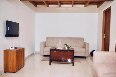 a living room with a couch and a coffee table at 50 Fables Vintage Kerala Pool Home in Pulpally