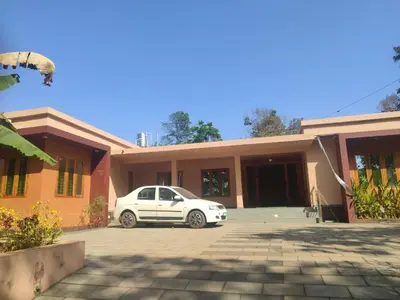 a white car parked in front of a house at AANMEEZ Homestay in Kuthuparamba