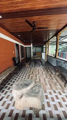 a room with two stools on the floor of a building at Spillway private pool villa in Meenangadi