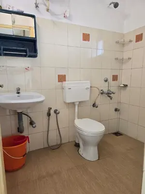 a bathroom with a toilet and a sink at The Western Castle Apartment - 2BHK Apartment in Kannur