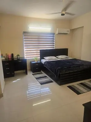 a bedroom with a bed and a window and rugs at The Western Castle Apartment - 2BHK Apartment in Kannur