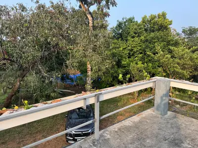 a metal railing with a plant on top of it at Spice garden farm stay in Kodali