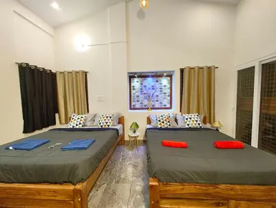 a bedroom with two beds and a window at shalom 3bhk in Mysore