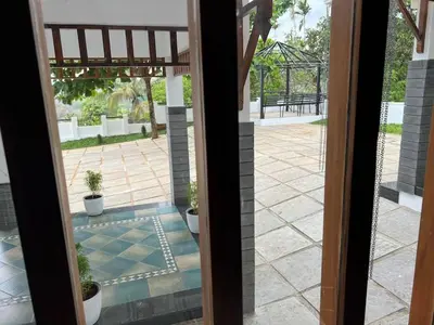 a view from the door of a patio at Petrus Signature Villa in Sultan Bathery