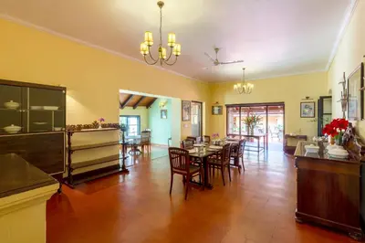 a large dining room with a table and chairs at amã Stays & Trails - Cottabetta Bungalow, Coorg in Gonikoppal