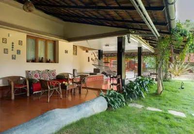 a house with a long pipe in the yard at Enteveedu Homestay in Panamaram
