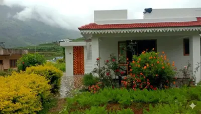 a small house with flowers in front of it at Vattavada Homestay in Vattavada