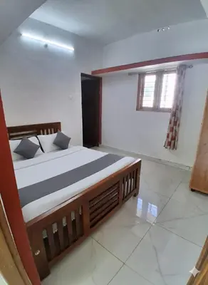 a bedroom with a large bed in a room at Vattavada Homestay in Vattavada