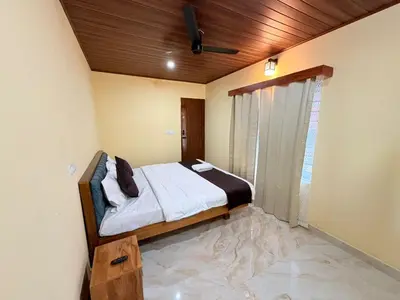 a bedroom with a bed with a wooden ceiling at VIVIPRA Habitat, Coorg in Madikeri