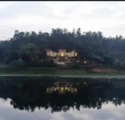 a house on the shore of a body of water at LAKE N DAZE by Masika stays in Ambalavayal