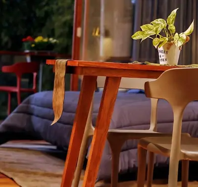a wooden table with a potted plant on top of it at LAKE N DAZE by Masika stays in Ambalavayal