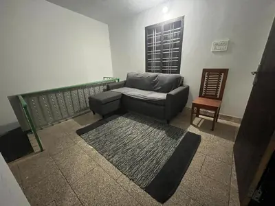 a living room with a couch and a chair at VY3 Homes in Vythiri