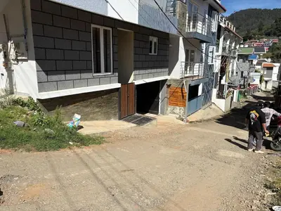 a couple of people standing outside of a building at BBR Residency in Ooty