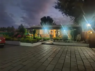 a house at night with lights on at Elephant County Resort in Masinagudi