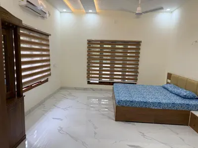 a bedroom with a bed in a room with marble floors at Premium house near Cochin Airport for NRI families in Nedumbassery