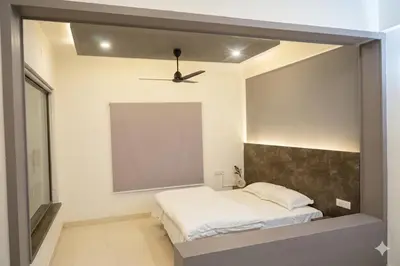 a bedroom with a bed and a ceiling fan at Aldhi Residency in Perintalmanna