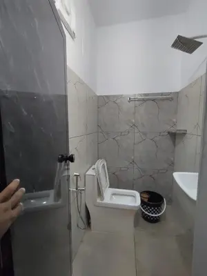 a bathroom with a toilet and a sink at Aldhi Residency in Perintalmanna