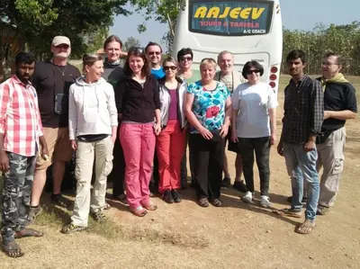 a group of people standing in front of a bus at Tiger Woods Homestay Kabini in Antarasante