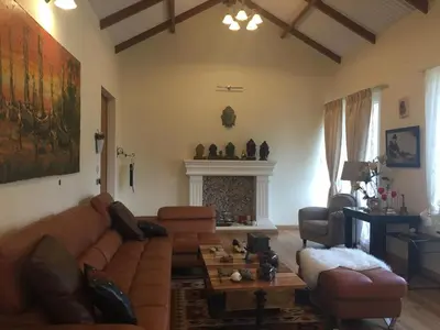 a living room with a couch and a fireplace at Neom Valley Stays in Ketti