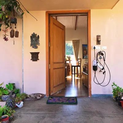 a door to a room with a cat laying on a rug at Neom Valley Stays in Ketti