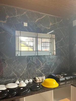 a kitchen with a counter top with a window at Village Villa in Vālpārai