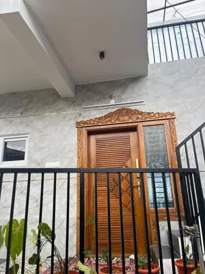 a wooden door on a building with a fence at Village Villa in Vālpārai