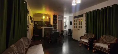 a living room with a couch and chairs and a table at Kodamukku water front cottage in Trichūr